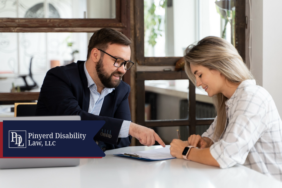 Attorney pointing to a document while a client signs it