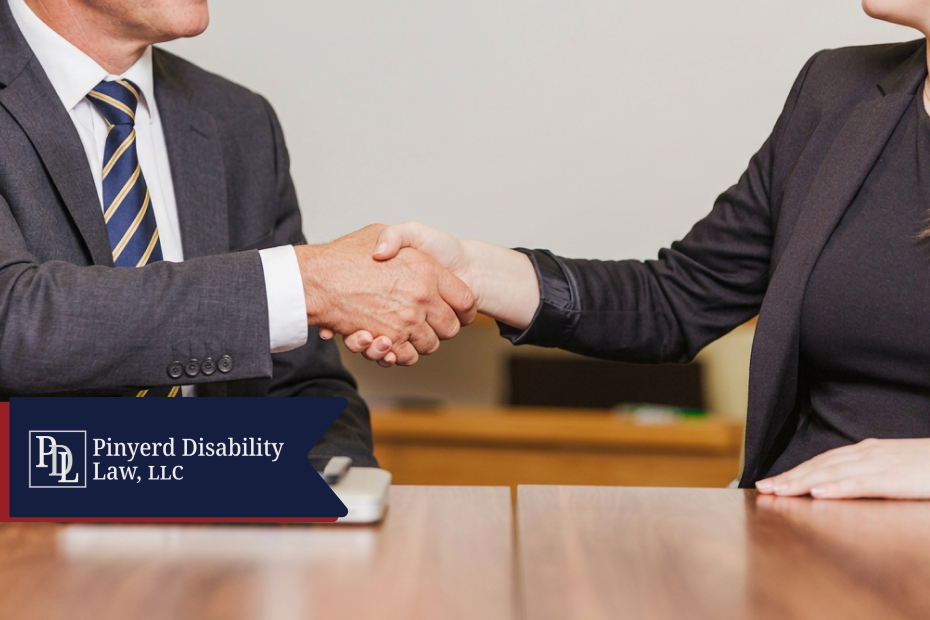 Close-up of a handshake between two professionals at a table