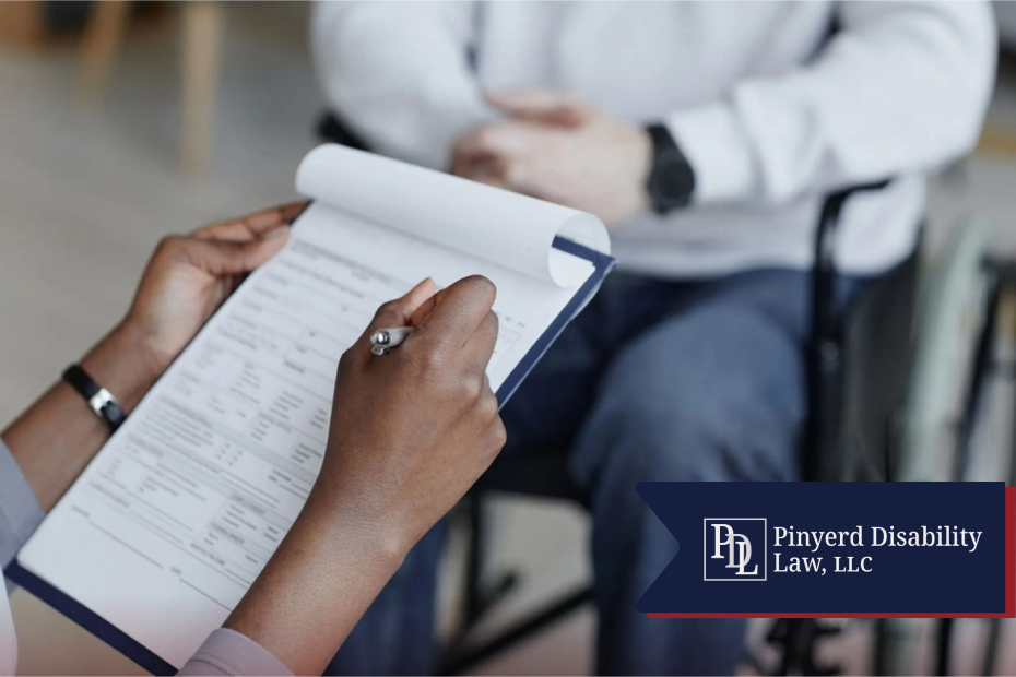 Person filling out a form on a clipboard beside someone in a wheelchair