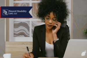 Woman on the phone taking notes at her desk