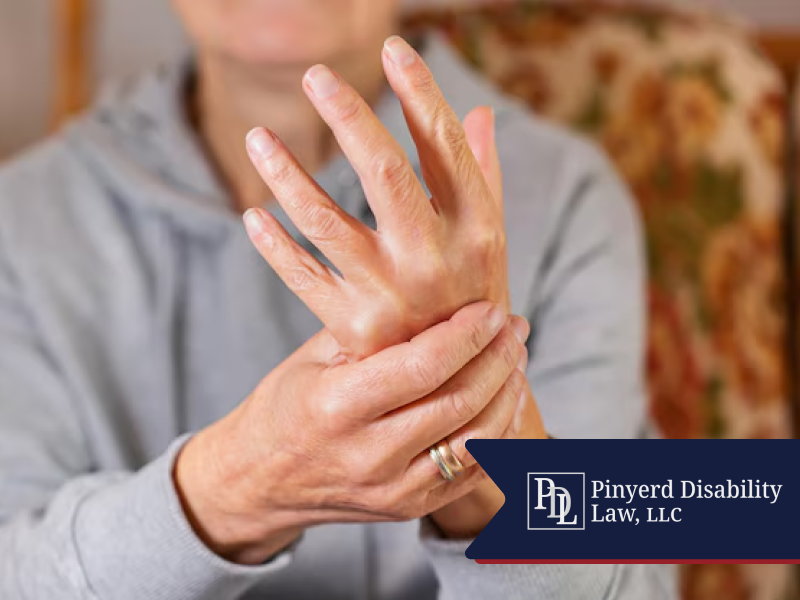 Person holding and rubbing an arthritic hand