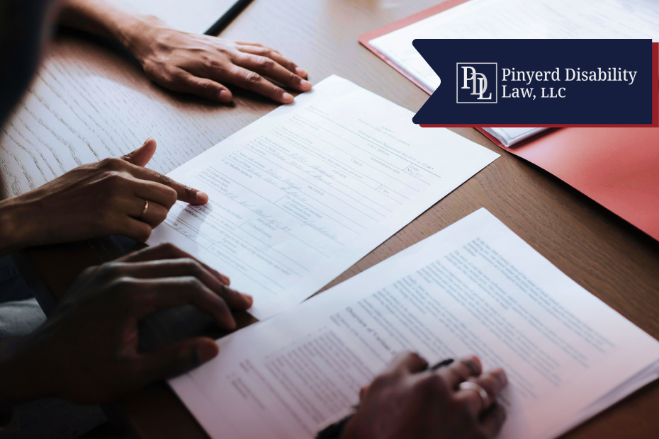 Hands pointing at forms and papers on a table