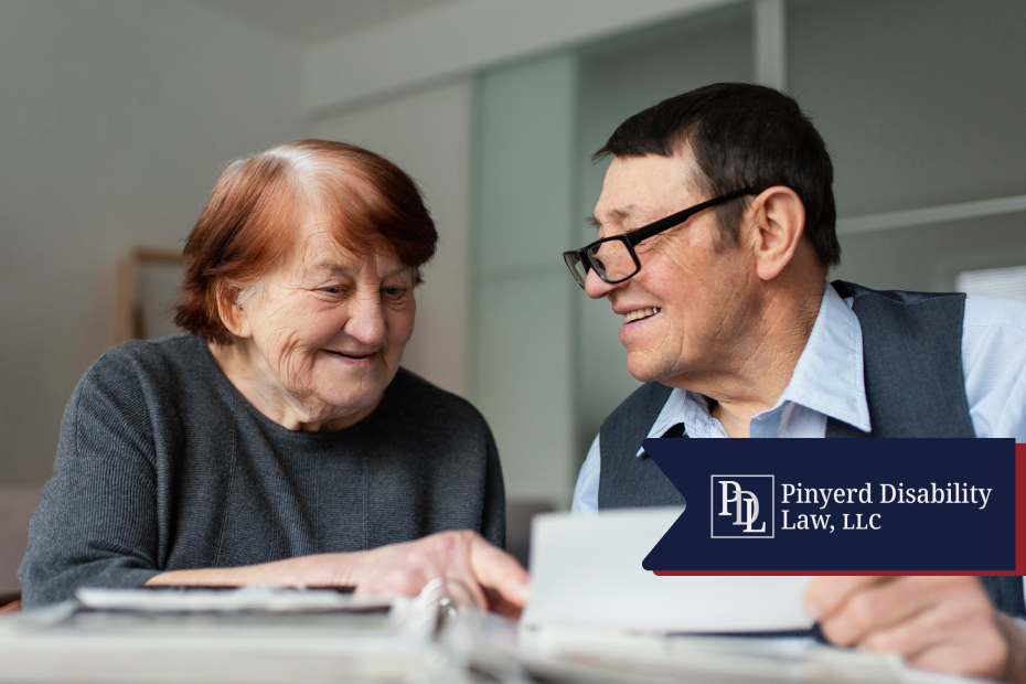 Older couple smiling while looking through paperwork together