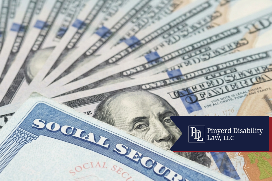 Social Security card on top of a fan of hundred-dollar bills