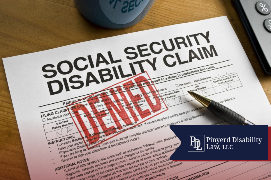 Denied Social Security disability claim form with a pen