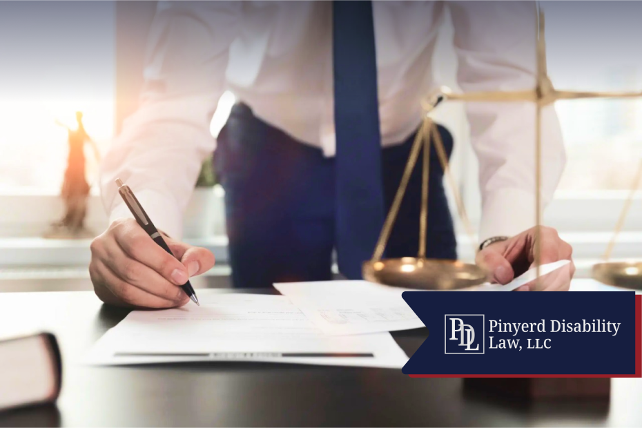 Attorney signing documents beside scales of justice
