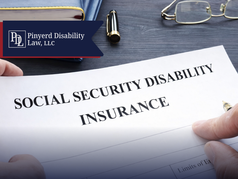 Social Security Disability Insurance form held in two hands