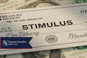 Check made out for stimulus resting on U.S. currency