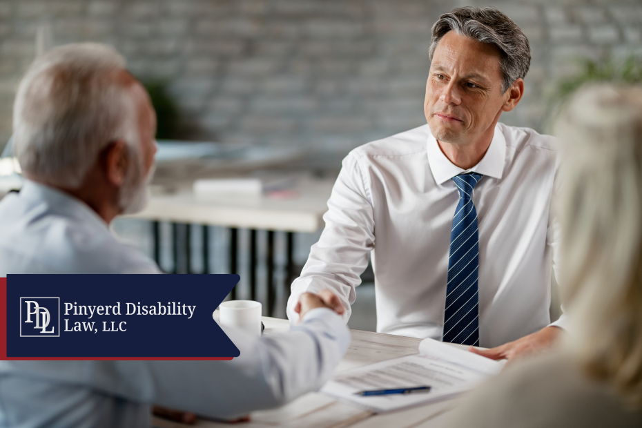 Attorney shaking hands with a client at a table