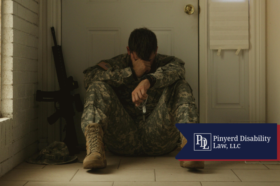 Soldier sitting on the floor with his head in his hand, holding dog tags