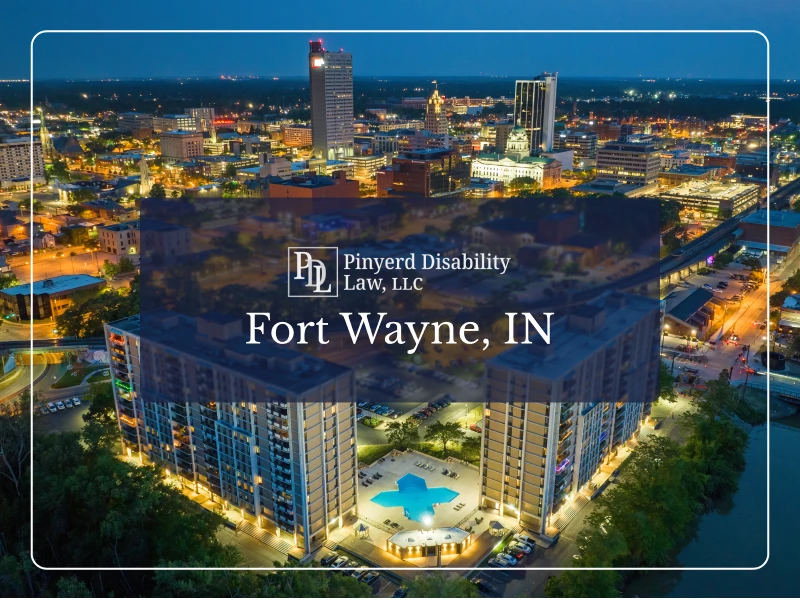 Aerial view of Fort Wayne, Indiana at night with the Pinyerd Disability Law logo